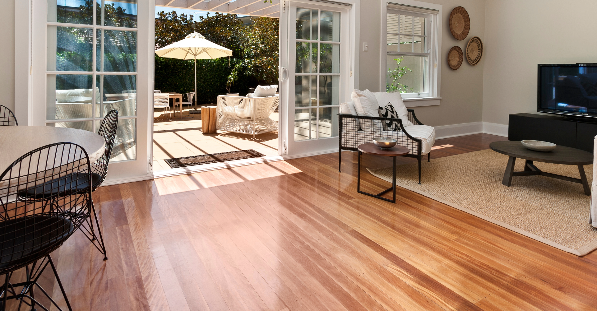 Family playing games in a living room with a hardwood floor